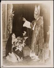 [The Archbishop blesses The Nun in "The Miracle".]
