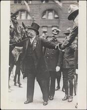 [Teddy Roosevelt in a parade in his honor.]