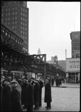 [Crowd of men gathered at Canal Street and West Broadway.]