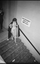 Art Students League Ball [Costumed woman walking down stairs.]