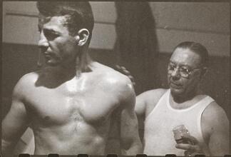 Rocky Graziano, He's a Good Boy Now [Man applying petroleum jelly to Rocky Graziano.]