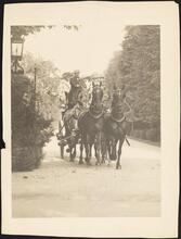 [August Belmont, Jr. driving a carriage with his wife Eleanor Robson Belmont, and their son August Belmont III and his wife Alice W. de Goicouria, through the gates of their Newport home "By-the-sea".