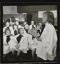 Orphanage [Girl singing in front of a choir.]