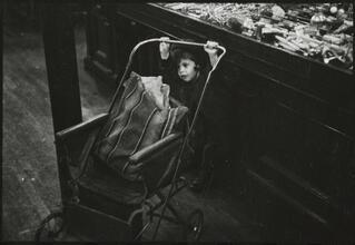 The 5 and 10 [Child with a stroller in Woolworth's.]