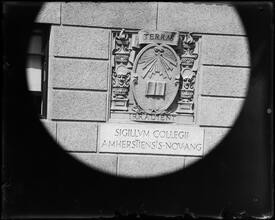 University Club seal on building wall.