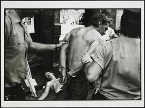 Police Work. A hot night in the Bowery. Police try to clear the sidewalk of sleeping drunks.