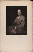 [Unidentified man in grey suit, holding a hat, cane, and gloves]