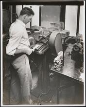 Interior, shoe factory with man at machine