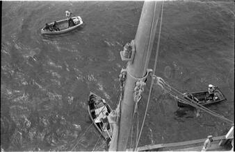 [Rowboats next to larger vessel.]