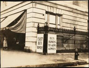 Street Scenes, etc. Showing Displays of Liberty Loan Posters during World War I [Liberty Loan sign attached to a fence.]