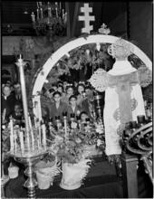 [Church congregation through a decorated altar.]