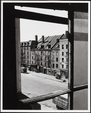 [Looking southeast through a window toward Schermerhorn Row.]
