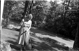 [Felicia Marsh sweeping off path.]