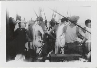 [Crew members on deck of ship.]