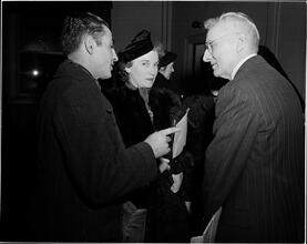 Dale Carnegie [Dale Carnegie speaking with a group of people.]