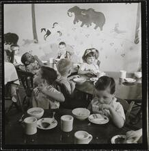 Orphanage [Children eating at tables.]
