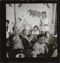 Orphanage [Children eating at tables.]