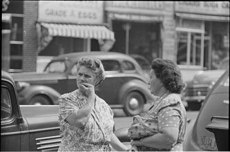 Street Conversations [Two women talking on the street.]