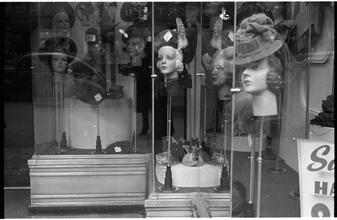 [Hat displays in store window.]