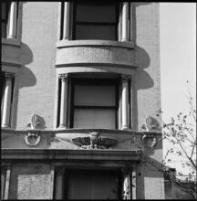 [Decorative owl sculpture on the façade of an unidentified building.]