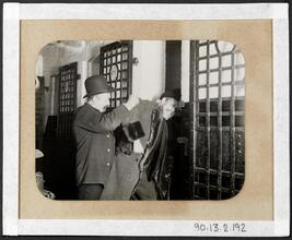 [Well-dressed man being thrown into jail.]