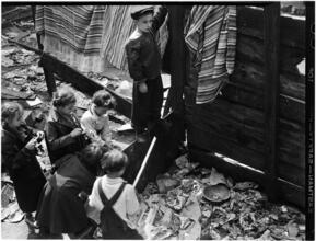 [Children looking through garbage.]