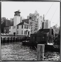 [Looking southeast toward Old Fulton and Water Streets from the edge of the East River.]
