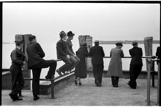 [People waiting on the dock of the Hoboken Ferry Terminal.]
