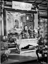 [Man at ornate altar.]