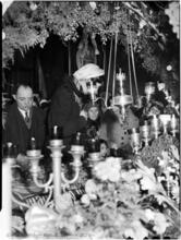 [Decorated altar with worshippers.]