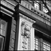 [Snarling lion sculpture on unidentified building.]