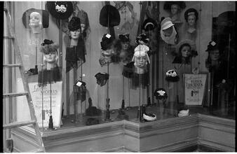 [Hat displays in store window.]