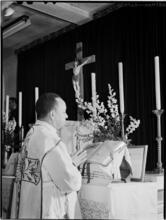 [Priest at altar.]