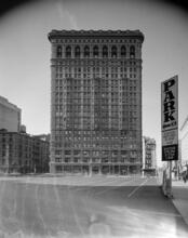 [Looking west across a parking lot to the Flatiron Building, 949 Broadway.]