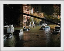 High tide flooding Avenue C, illuminated by 9th Precinct police station, Manhattan