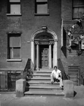 [Man sitting on the stoop of 51 Market Street.]
