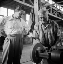 Circus [Two men looking at a machine.]