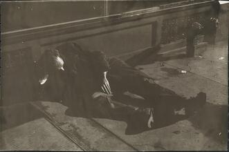 [Destitute man on sidewalk.]
