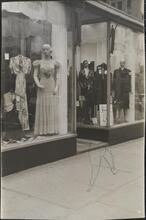 [Clothing displays in store window.]