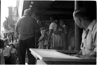 [Crowd watching Palace of Wonders performers from midway.]