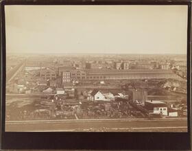 [View from the roof of George Ehret's home at Park Avenue and 94th Street.] Looking north by east. Shows car barn (Round House for Third Avenue El).