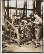 Interior, shoe factory with man at machine
