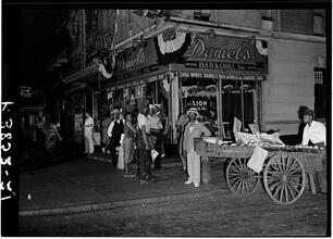 Street Scene in Harlem in front of Daniel's Bar and Grill.