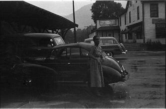 [Felicia Marsh standing next to car.]