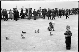[People waiting on the dock of the Hoboken Ferry Terminal.]