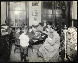 Organized Charity. Family making artificial flowers.