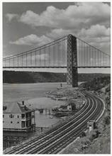 The Hudson River looking north from below the George Washington Bridge. Showing railroad tracks and the George Washington Bridge.