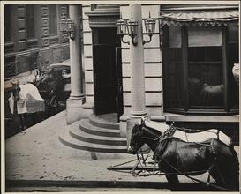 [National Bank building with horse carriages out front.]