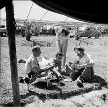 Circus [Group of people playing cards, one is dressed like a clown.]