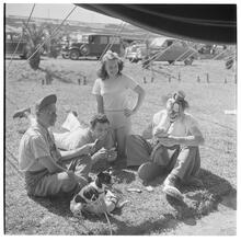 Circus [Group playing cards, one is dressed like a clown.]